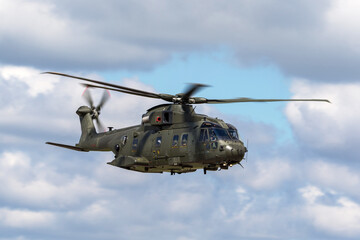 Fototapeta na wymiar Large green army helicopter flying.