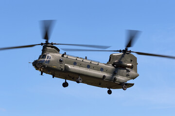 Large twin rotor military helicopter coming in to land.