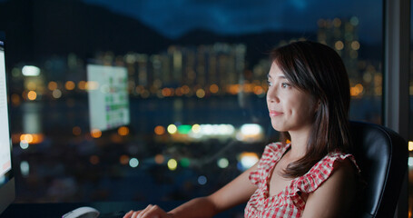 Woman work on computer at night