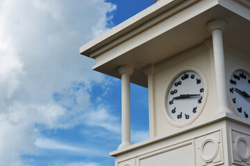 Classical white pattern clock tower With clouds and sky as a backdrop