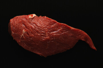 Fresh raw beef steak, meat on a black background, close up.