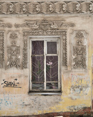 Details of the facade of the old building, an old shabby wall, a decorative wooden window aperity, Rybinsk