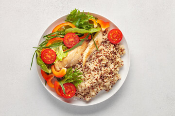 Diet lunch - chicken breast with quinoa and salad of fresh vegetables and leaves. Top view