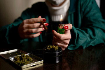 Young woman with face mask smoking weed flame lighter hands nails marijuana 