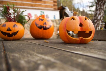 Three beautiful cute Halloween pumpkins on the table, each different, greeting customers