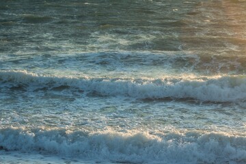 the waves of the black sea illuminated by dawn