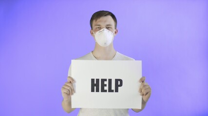 Young Man Activist With mask on face and with HELP Poster on Violet background