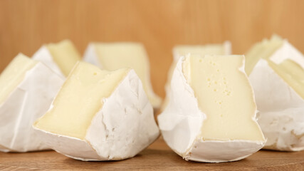 Fototapeta na wymiar soft cheese Camembert Delicious pieces of white mold cheeses with soft textures Camembert close up