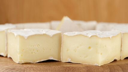 Fototapeta na wymiar cheese Camembert or brie. Delicious pieces of white mold cheeses with soft textures Camembert close up