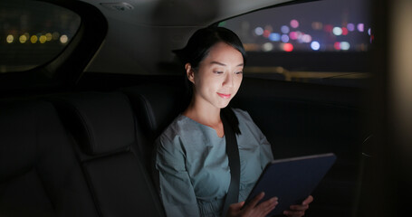 Woman work on tablet computer on car