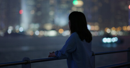 Woman look at the city at night