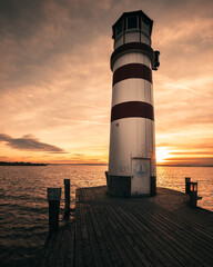 Ocean sunset with lighthouse in podersdorf austria