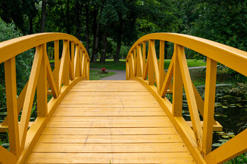 Empty arched wooden pedestrian bridge