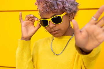 portrait of young afro american girl with hand avoiding photo