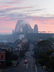 Foggy dawn view of Sydney Harbour Bridge.