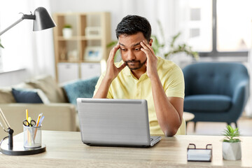 technology, remote job and business concept - disappointed indian man with laptop computer working...