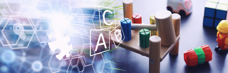 Children's development. Children's wooden toy on the table in the play area. Room of children's...