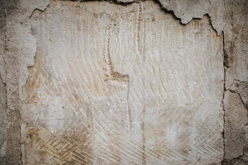 Plaster peeling off brick wall. The foundation of a residential building is gradually collapsing