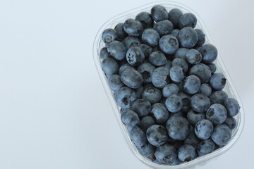 blueberries in a plastic box top view close up