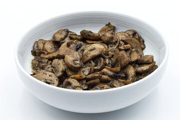 Bowl of cooked mushroom isolated on white background