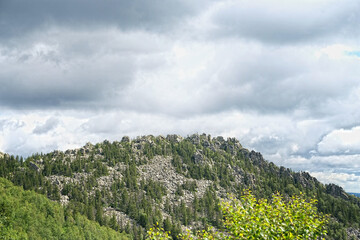 summer landscape in mountains. mountain rocks, slopes of Southern Ural. travel trip backdrop. national Park Taganay, Russia.