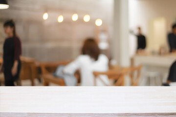 cofee shop blurred background with wooden desk space montage.