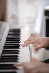 selective focus on  little hands of a girl practice piano lesson