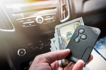 man hold dollar and car key for pay rent or bribe