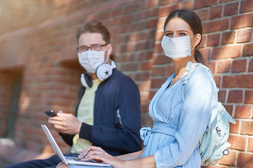 Couple of students in the campus wearing masks due to coronavirus pandemic