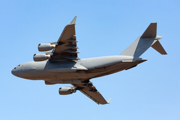 Large four engined military transport jet flying.