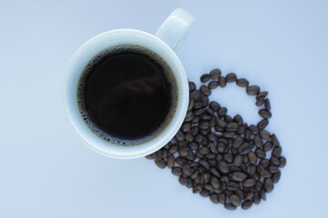 mug of coffee. the shadow from the coffee bean