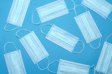 Disposable blue medical face mask on blue background