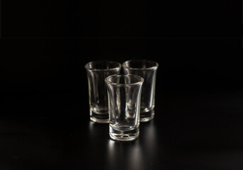 Empty shot glasses  for alcohol cocktail on black background.