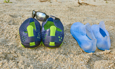 deserted beach shore, sea beach, bay shore, small shell rock, swimming shoes, sunglasses,