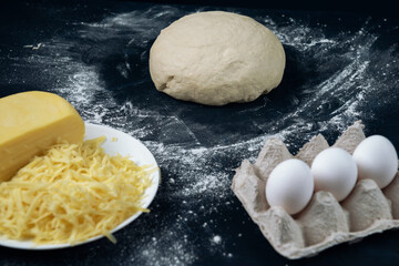 A piece of yeast dough with cheese and eggs. Process of making bakery. Adjarian Khachapuri Recipe – Georgian cheese bread.