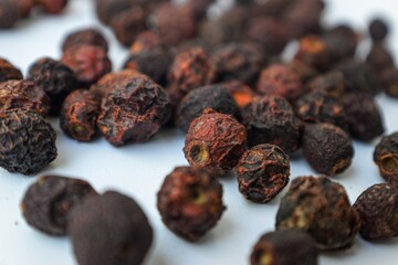Dried cherries with bone inside on a white background scattered.