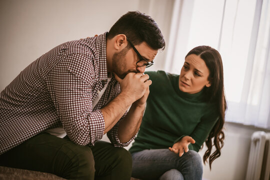 Man Is Sad And Depressed, His Wife Is Consoling Him.