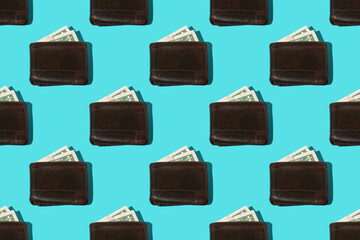 Colorful pattern: one dollar banknote in an old leather wallets on blue background, close-up, hard shadow