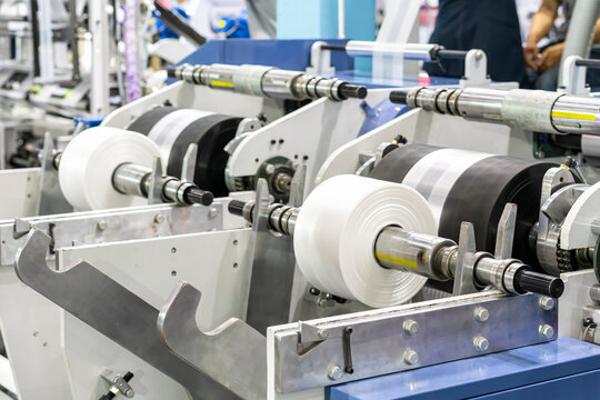 raw material plastic roll set on support unit shaft for supply or feed to modern automatic blow or injection for continuous manufacturing process sack bag making machine