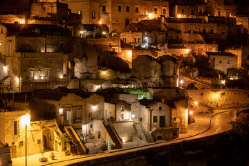 Amazing lighted buildings in ancient Sassi district by night in Matera, well-known for their ancient cave dwellings. Basilicata. Italy