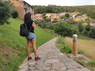 Fototapeta na wymiar Woman enjoying wonderful views of a charming town in Spain. Hiking on vacation