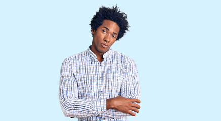 Handsome african american man with afro hair wearing casual clothes skeptic and nervous,...
