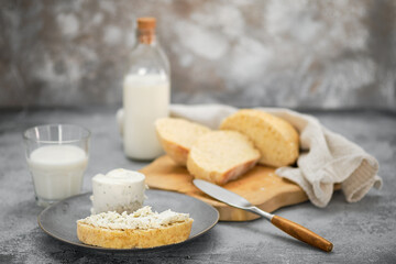Sandwich with homemade yeast-free bread, soft cheese and milk