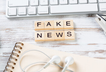 Fake news concept with letters on cubes