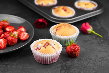 Strawberry muffin dessert with fresh strawberry on dark background - summer pasrty