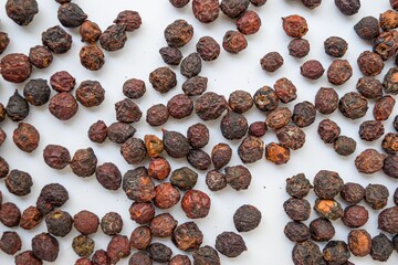 Dried cherries with bone inside on a white background scattered.