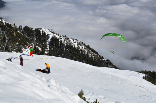 Paraplan flying in the snowy Alps.