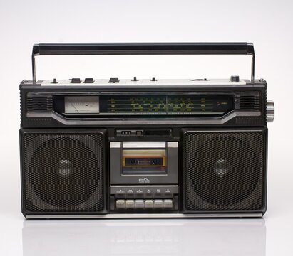 Vintage black boom box on white background with reflection