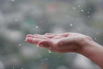 Fototapeta na wymiar hands in the rain