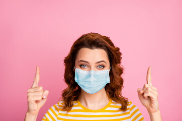 Close-up portrait of her she nice attractive wavy-haired girl wearing safety mask pointing up copy space infection influenza vaccine therapy syndrome disease isolated over pink color background